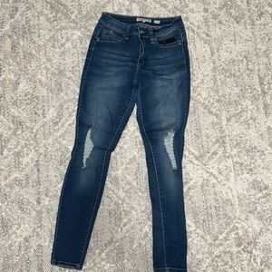 Dark jeans, distressed on the knees
